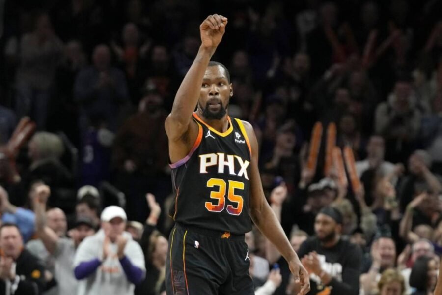 Phoenix Suns forward Kevin Durant gestures after he made a 3-pointer against the Sacramento Kings during the second half of an NBA basketball game Tuesday, Jan. 16, 2024, in Phoenix. The Suns won 119-117. (AP Photo/Ross D. Franklin)